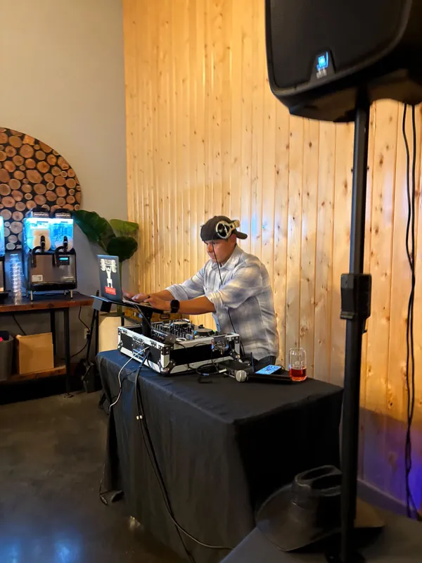 Hector at the decks in a wood-paneled room